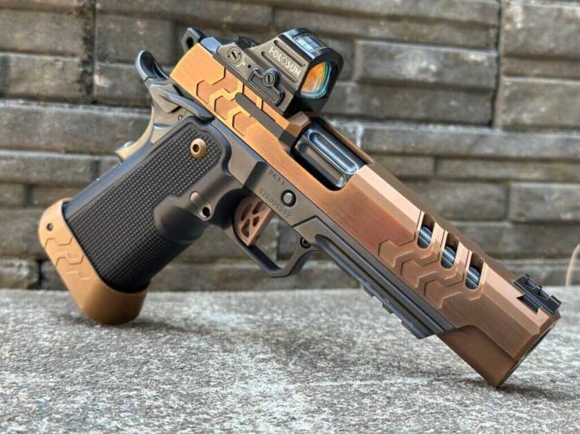 Bronze and black two-tone 2011 2K11 Target (OR) posed on a cement and stone background.