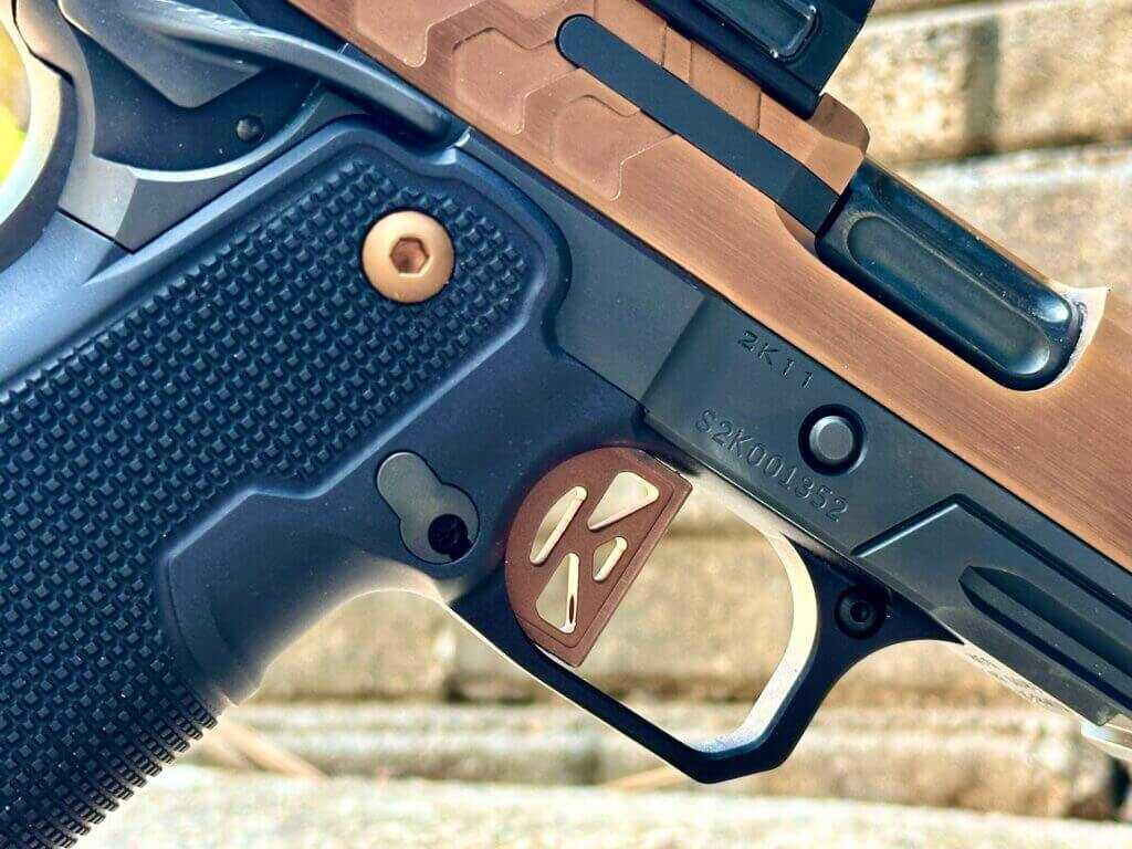 Closeup shot of the ejection port and trigger on a 2011. 