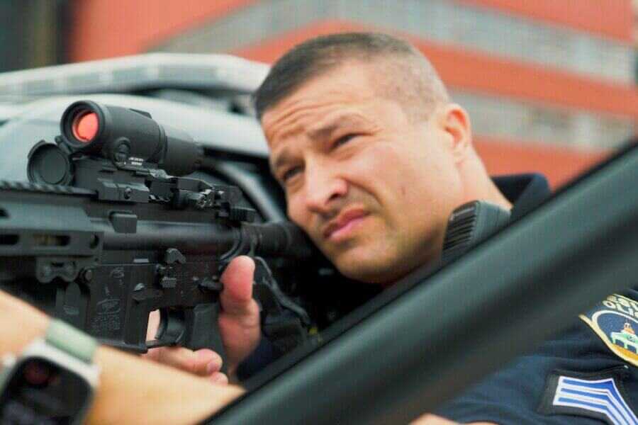 A man looking through an Aimpoint Duty RDS MR.