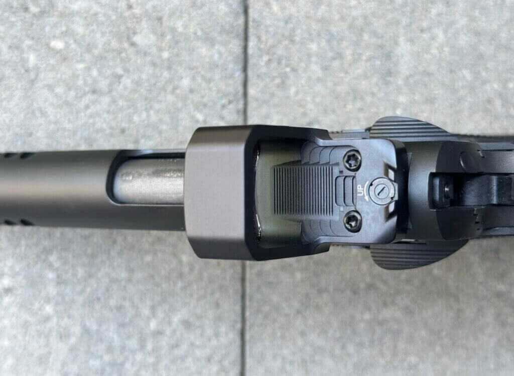 Top-down closeup view of a red dot optic mounted on a pistol. MAX