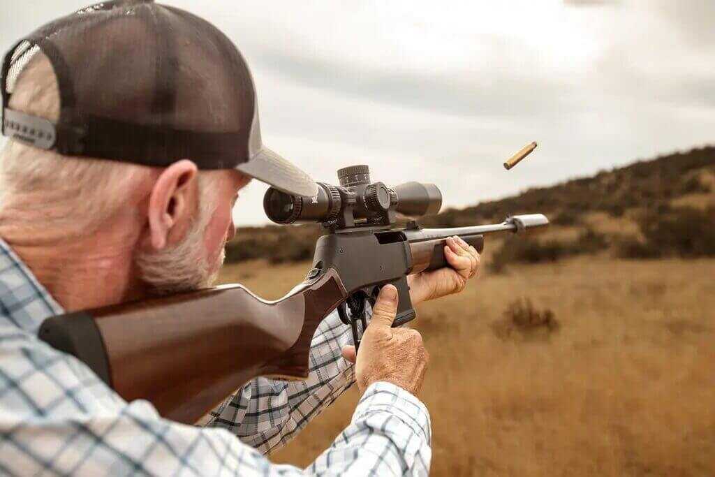 Shooter running the Henry Lever Action Supreme at the range with Vortex Viper HD optic