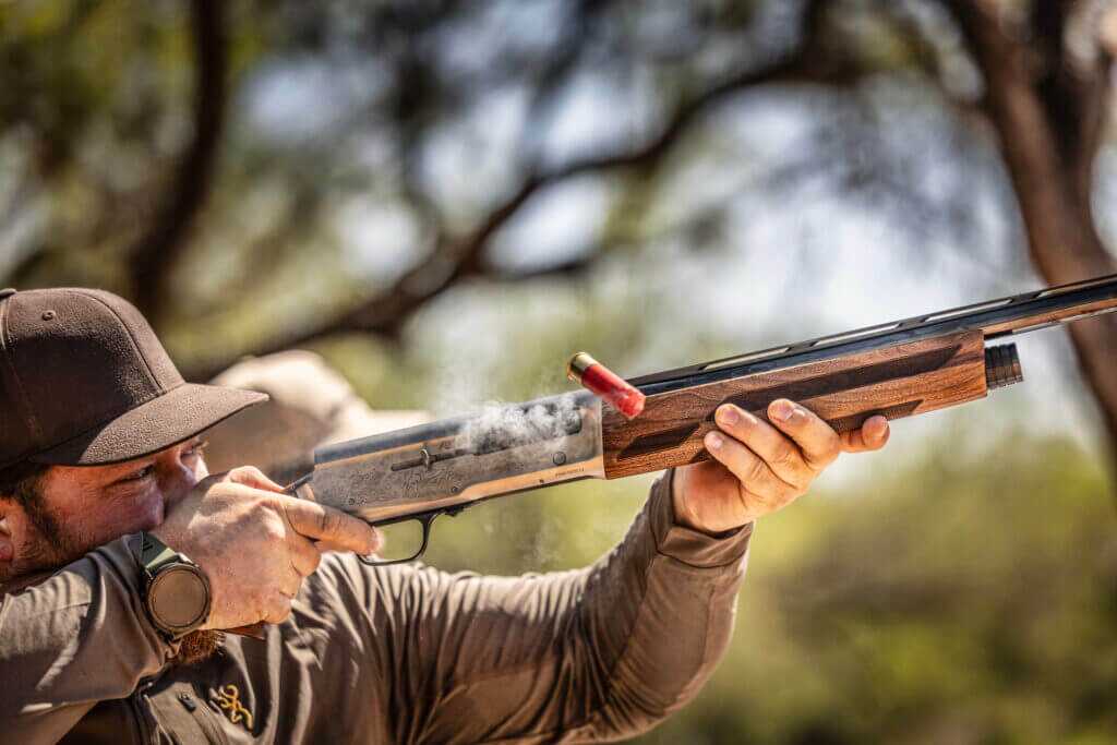 Smiling shooter running a suppressed Browning A5 with Banish 12 during dove hunt