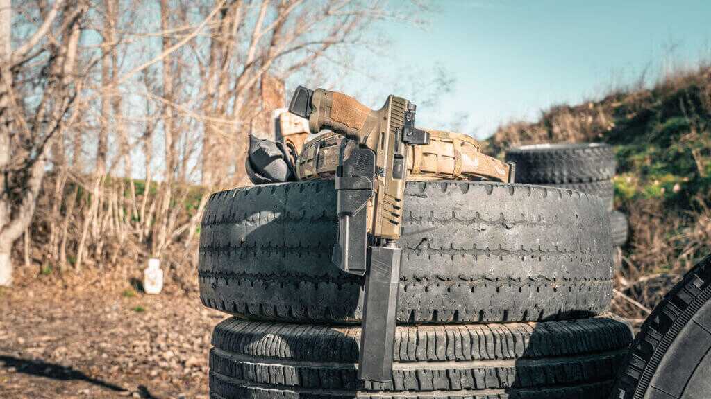 SAR9 SOCOM holstered in a HUSH suppressor compatible holster