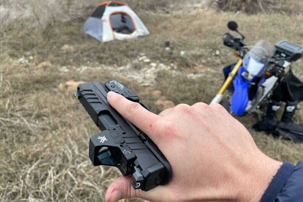 Echelon 4.0C grip texture with dirt bike and tent in background at riverside camp