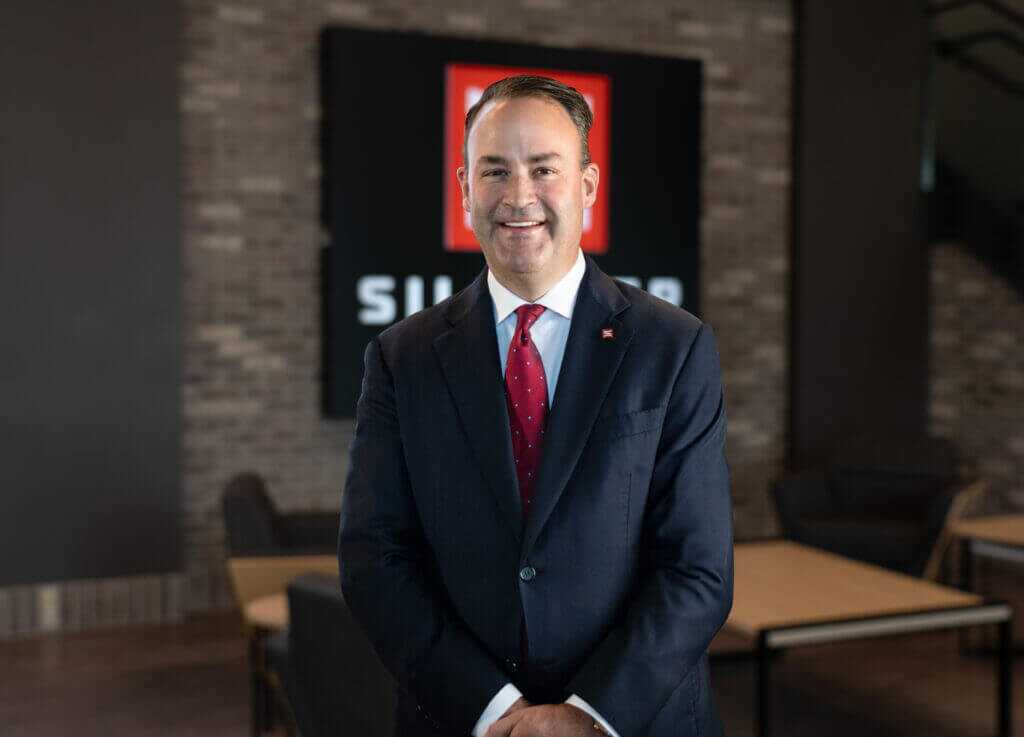 Brandon Maddox of Silencer Central stands in front of company signage before SHOT Show 2026