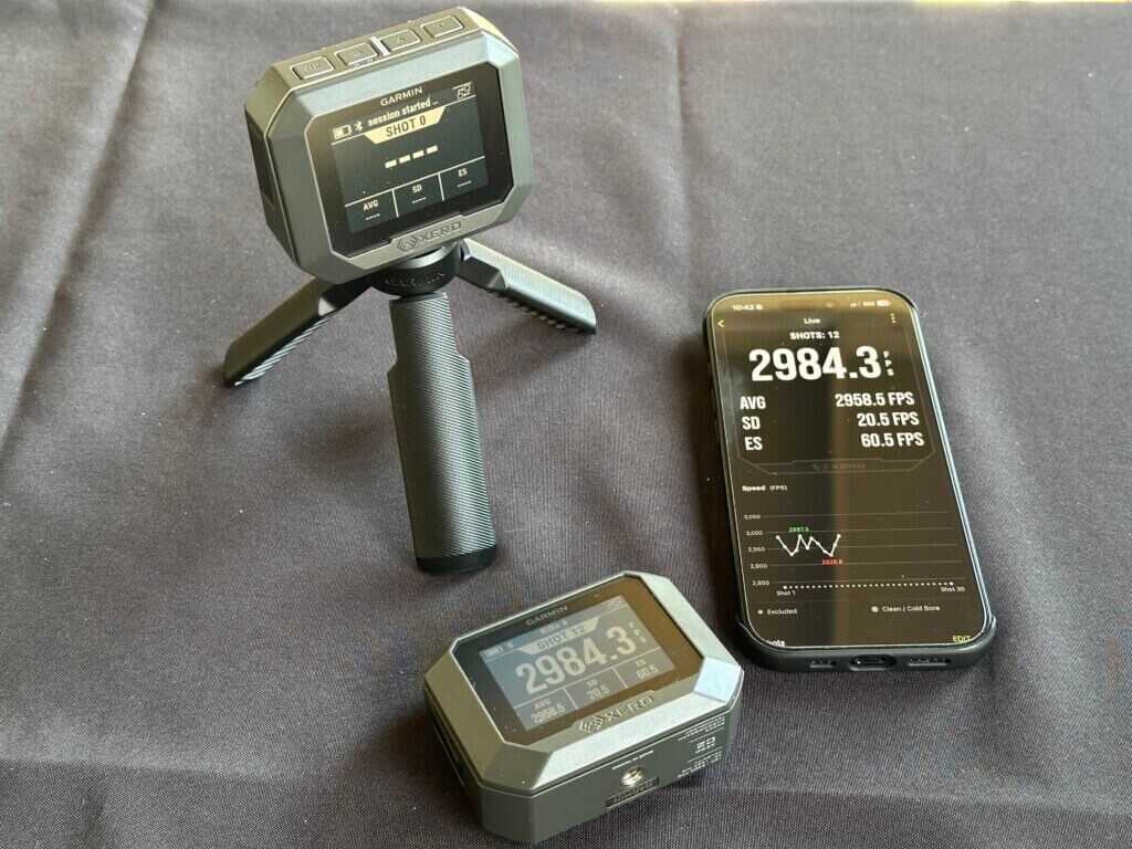 A green chronograph is staged on a black backdrop.