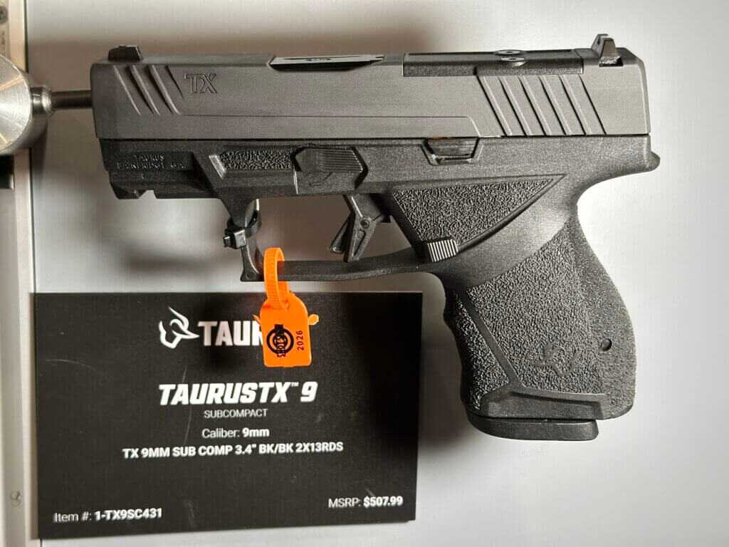 A black pistol is shown on display.