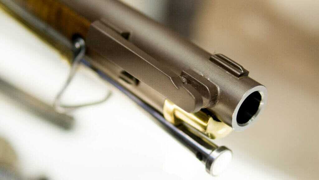 Close up photo of the muzzle, showing the bayonet mount on the gun's right side, the front sight, and the end of the ramrod.