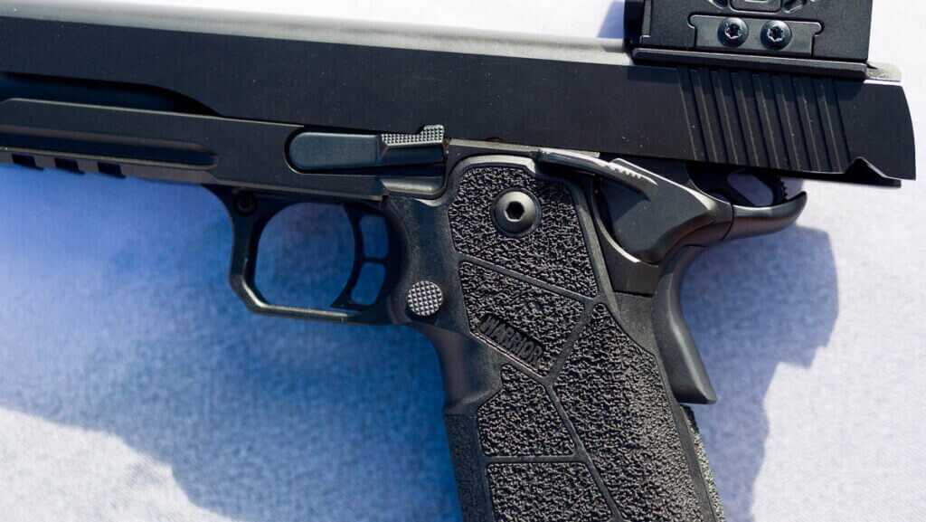 close up view of the Left side of the gun showing controls and grip