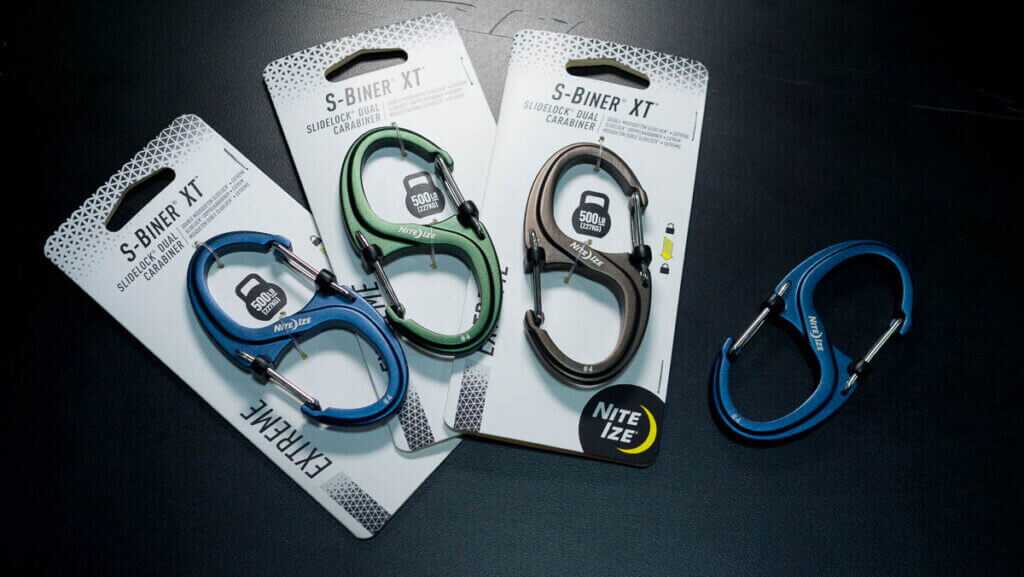 4 of the product lying on a black table, three of them in packaging.