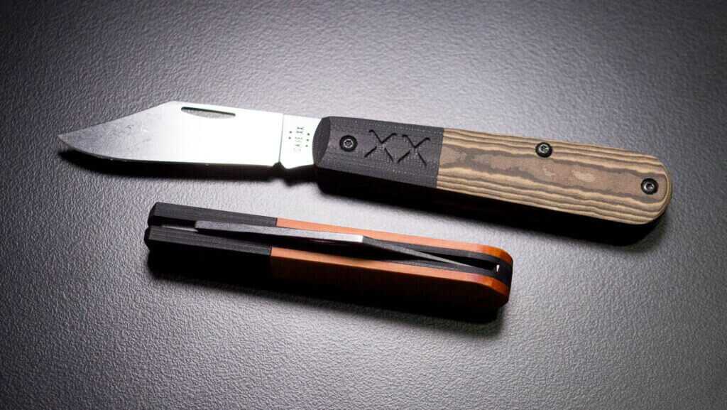 two knives, one open, the closed one set on its back edge.