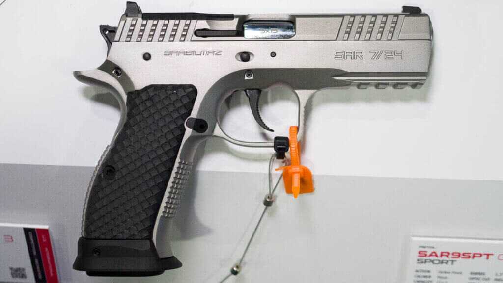 The whole gun on a table, facing right.