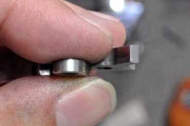 Smooth the two faces that engage the sear, but keep it all square.