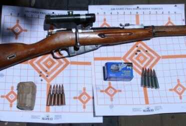 The one with the green scope as sold to be as a 1/2 MOA rifle. It averaged about 1.5 MOA in real life. 