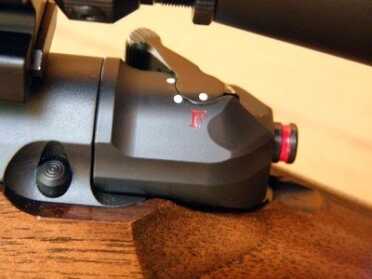 The exposed red circle indicates that the bolt is cocked. The forward position of the safety lever and the white dot on the “F” indicates it’s ready to fire.
