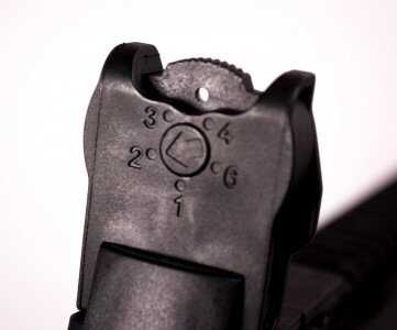 The rear sight has an aperture wheel calibrated for different ranges.
