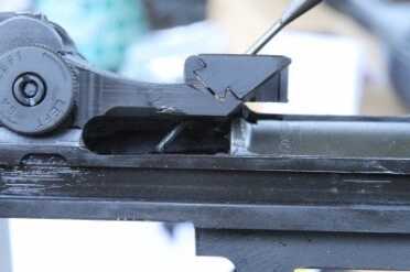 This is the dovetail that holes the stripper clip guide on the M1A. As you can see, I am pushing the lock pin out with a 3/32 punch.