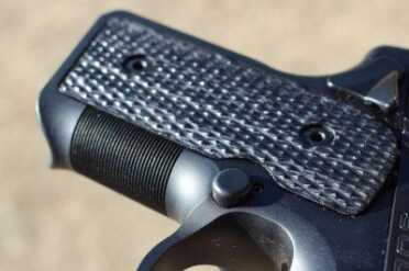 The frame does have a small lip that would help in the removal of a stuck magazine. 