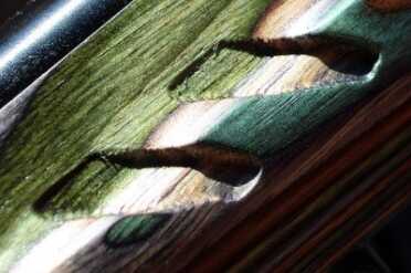 The forend has heavy texture carved into the wood.