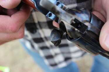 On half cock so the cylinder will spin to load. 