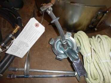 Here you can see the gas cap adapter and the two tubes (bottom left) that my stove was missing from the kit that are used with the adapter to allow the can to breath while the fuel drips out. 