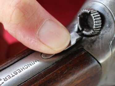 Push the button down and turn the knob to take the stock off the receiver. 