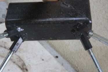 This stove has nifty welded on feet. Others have a crossbar on the back to hold them upright. 