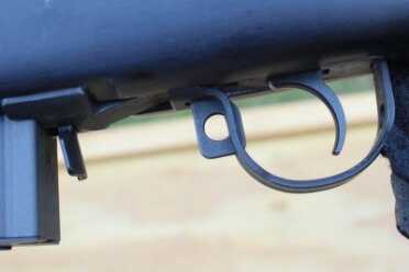 The safety is easy to use. Push forward to fire.