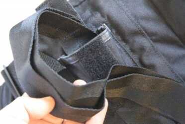 The Blackhawk has these little compartments on the back that hold tow straps. They could be hook around head and arms, or connected to a litter