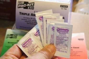 You can get triple antibiotic ointment in packets from Pac Kit, along with Zinc Oxide, and burn cream. Amazon carries all of the industrial Pac Kit supplies. 