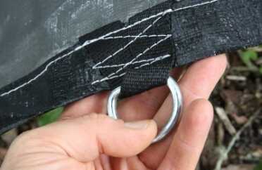 The other side of this tarp is silver. I would reverse the drain in a survival situation. Note the heavy D rings.