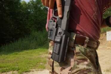 Note that the finger is left on the frame, and doesn't fall into the trigger--which is the common gripe about some retention holsters.