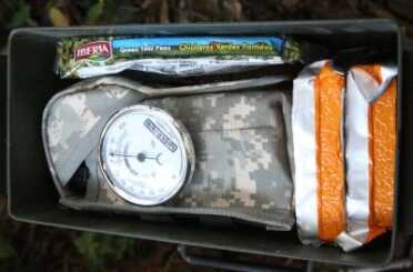 An AR, six full mags, some ready food and some cookable dried food, all packed up. Note the humidity level. 