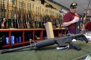 Gun Sales Set Record on Black Friday A gun-shop owner checks out the merchandise. (Photo: Reuters/Shannon Stapleton)
