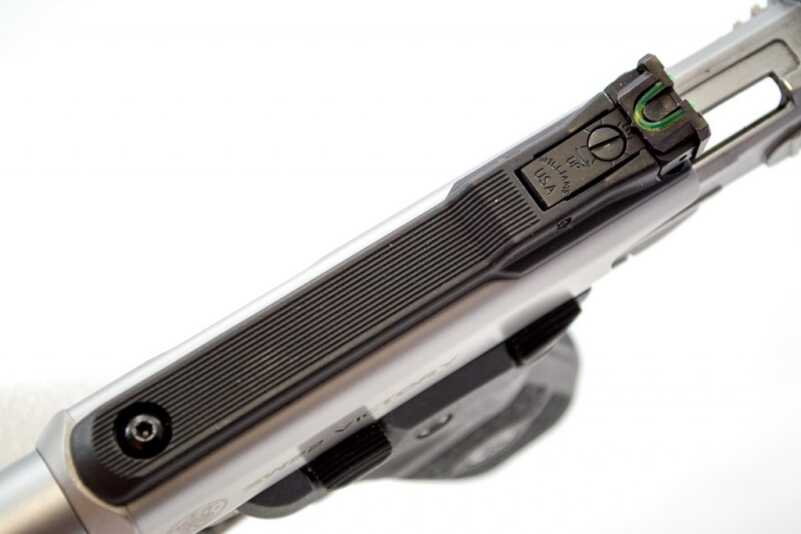 The rear sight is adjustable and features a fiber optic tube.