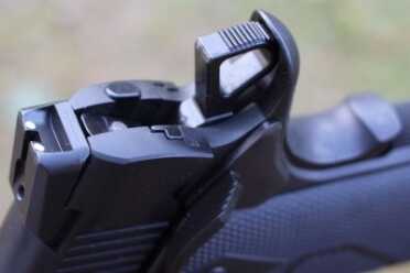 New Gun Review: Springfield 1911, Loaded Parkerized with Crimson Trace Skeleton hammer and beaver tail.