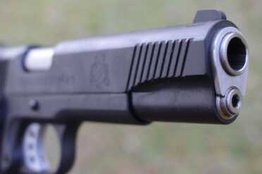 New Gun Review: Springfield 1911, Loaded Parkerized with Crimson Trace Front striations on the slide.