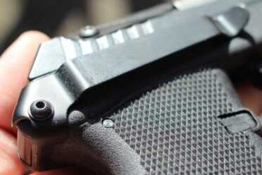 The Kel-Tec attaches to the back of the frame. Pull a pin, plug it in, done.