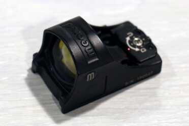 The new red dot is very low, so low that it should co-witness with factory sights. 