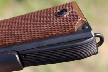 Arched mainspring housing and WWII style grips. 