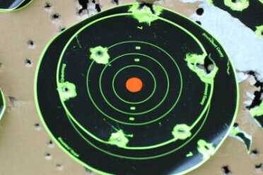 We shot standing at 100 yards with the irons. The results aren't MOA, but this is standing with a very heavy gun shouldered.