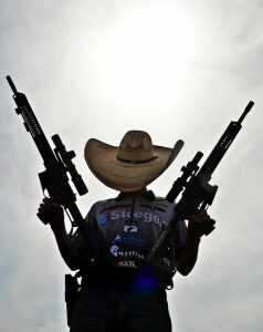 Sean Yackley with his Adams Arms rifles, ready for the sun, and any challenge thrown at him.