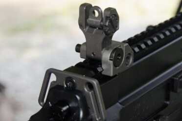 The folding rear sight unit features dual apertures and locks solidly into place. 