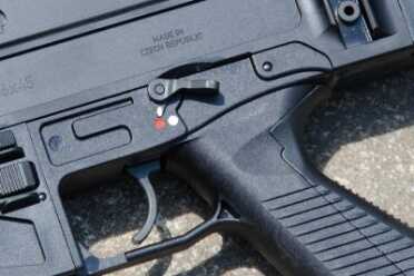 The selector switch and magazine release are both ambidextrous. Note the colored marking positions for the safety selector.