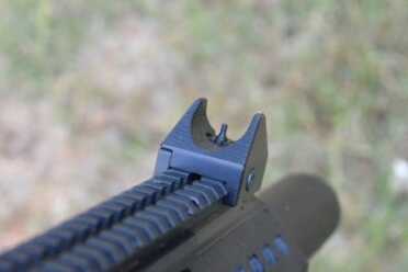 The front sight of the carbine is a post unit protected by heavy-duty dual wings.