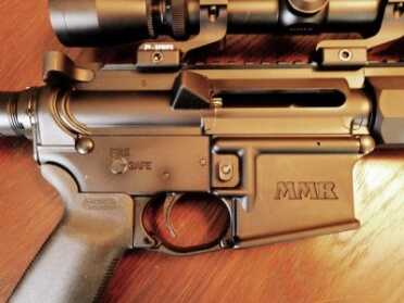 Mossberg eliminated the forward assist and dustcover. It makes the MMR a little easier to maintain and less expensive to produce. Note the enlarged Magpul trigger guard.