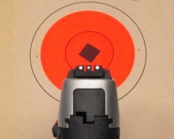 The black polymer sights have a white 3-dot pattern. The rear sight is adjustable for both windage and elevation.