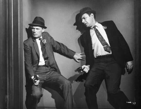 Two men holding revolvers

