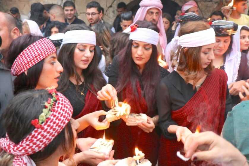 middle eastern women standing around with candles