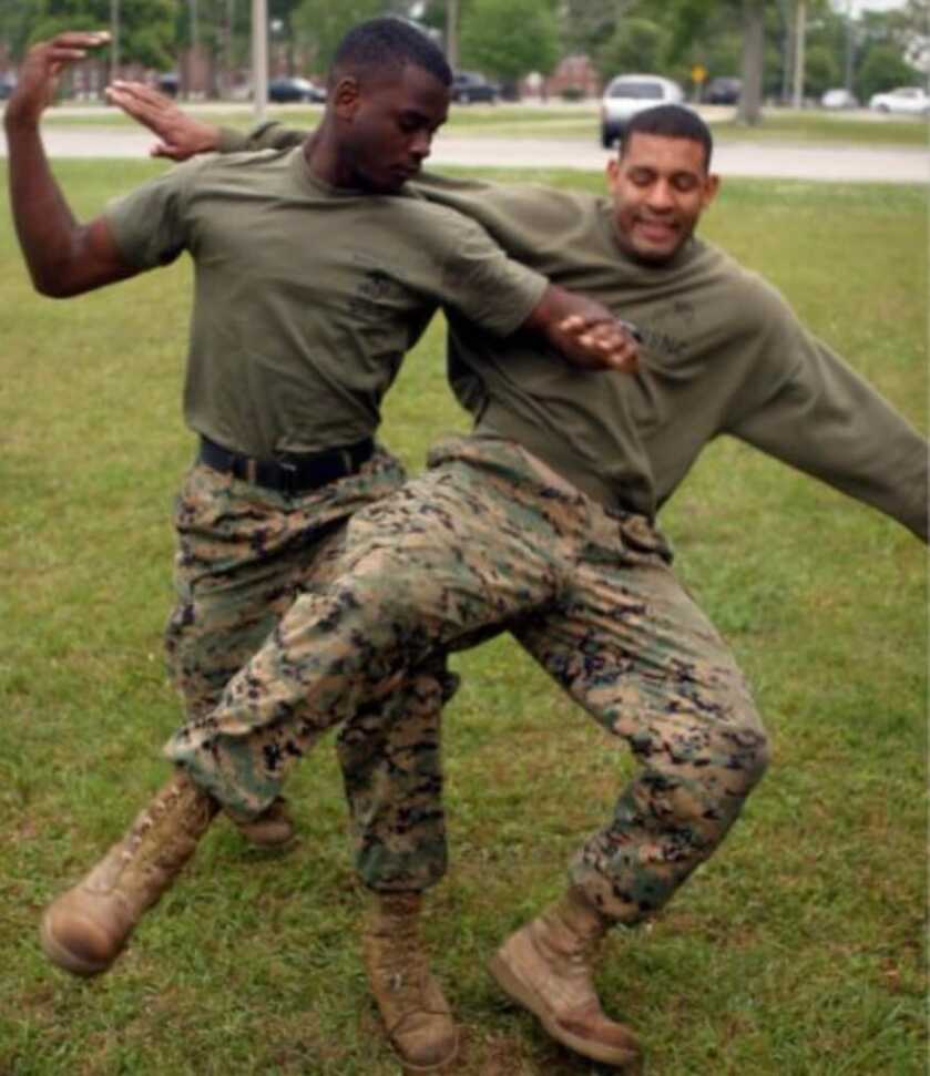 two soldiers practicing martial arts on a grass 